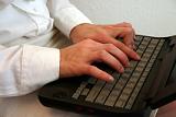 Hands typing on a keyboard during a workstation assessment.