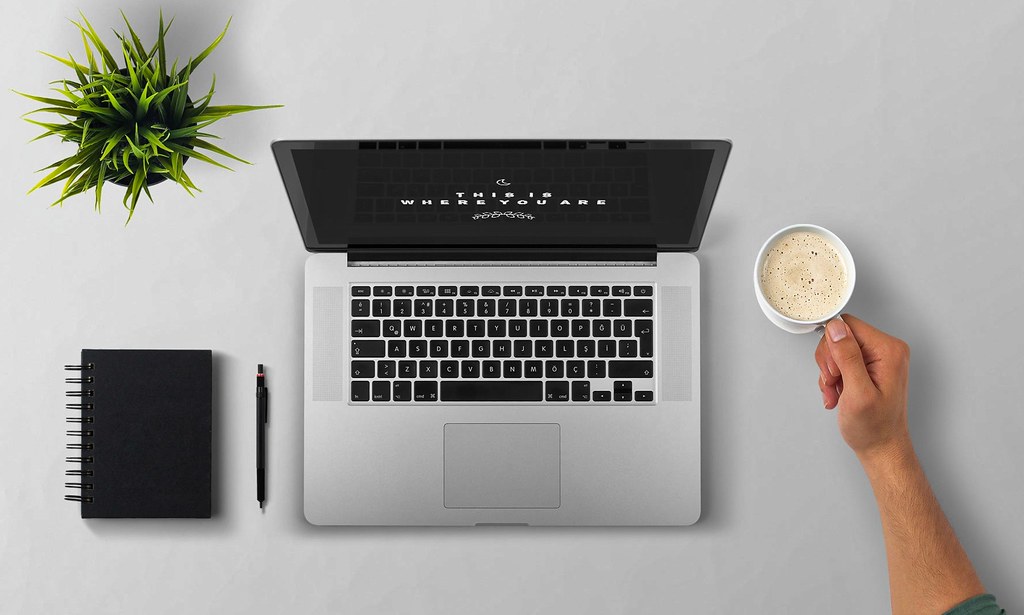 Office workstation with monitor, keyboard, and laptop used for ergonomics planning.