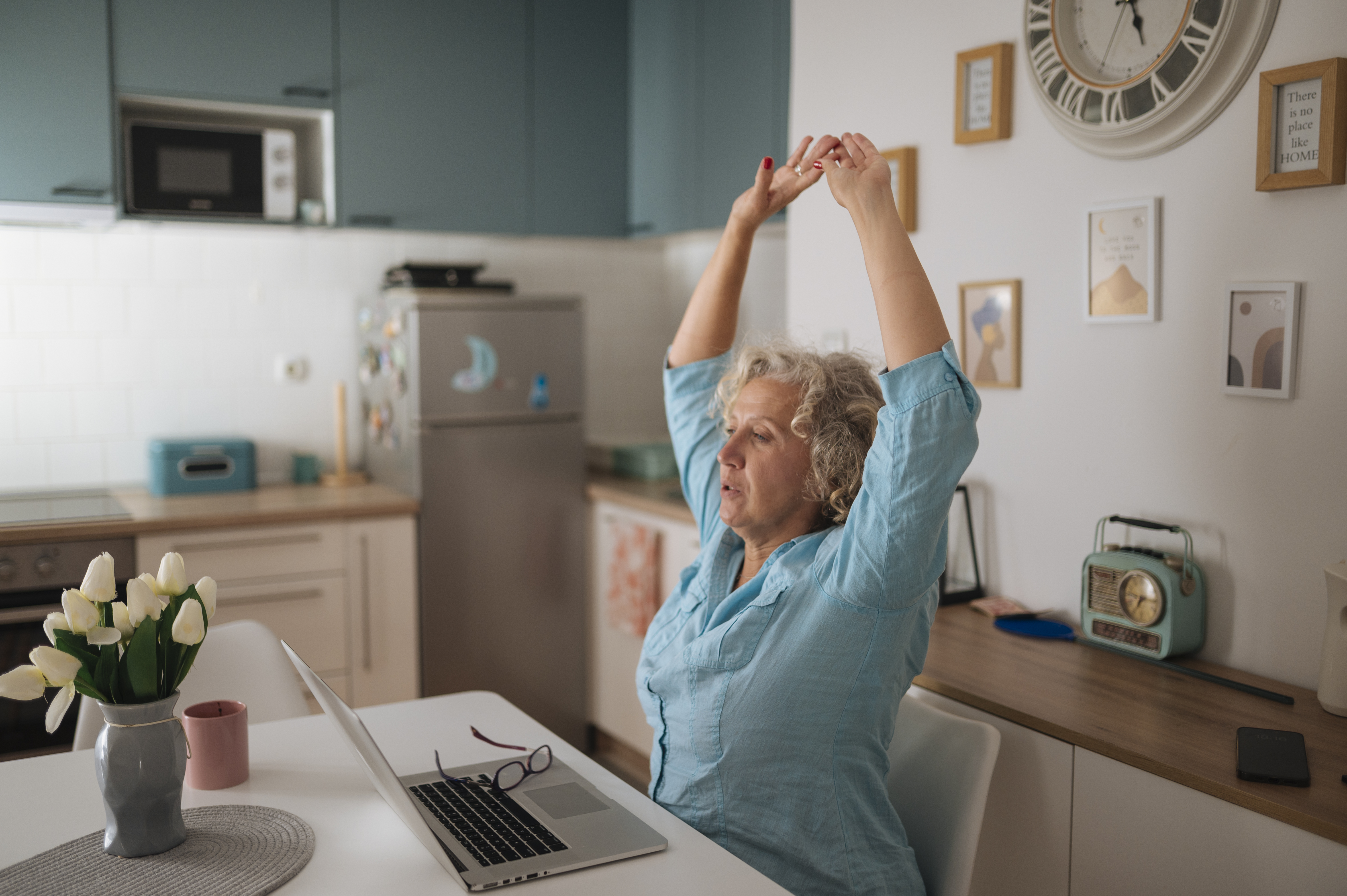 Employee performing a seated ergonomics stretch during a work break